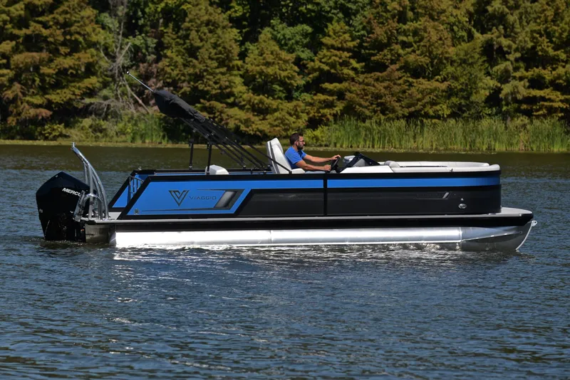 Slide: The Image of 2023 Viaggio D23S Platinum pontoon boat cruising on a lake. - 6