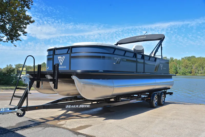 Slide: The Image of 2023 Viaggio L22Q pontoon boat on a trailer by a lake. - 10
