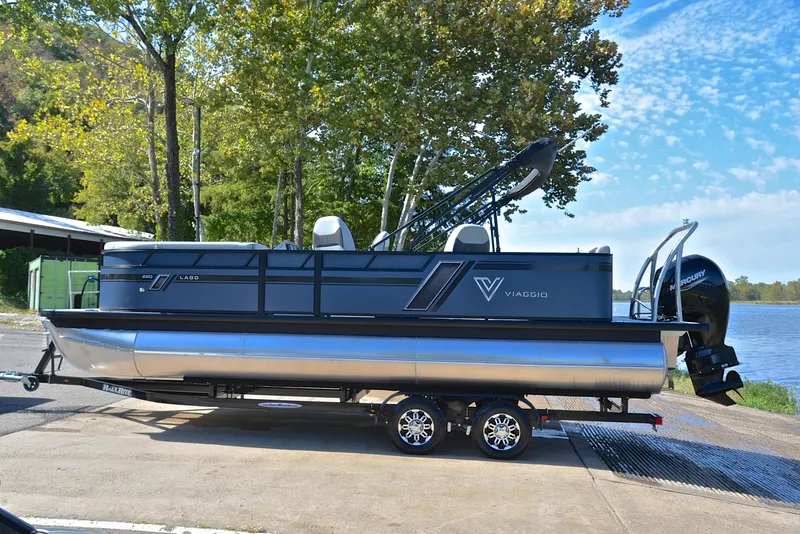 Slide: The Image of 2023 Viaggio L22Q pontoon boat on trailer by a lake. - 11