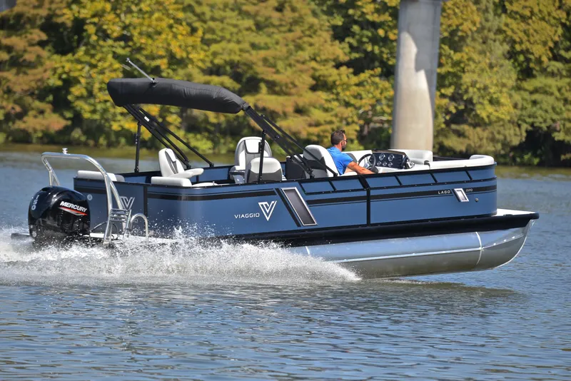 Slide: The Image of 2023 Viaggio L22Q pontoon boat cruising on a lake with a Mercury outboard motor. - 5