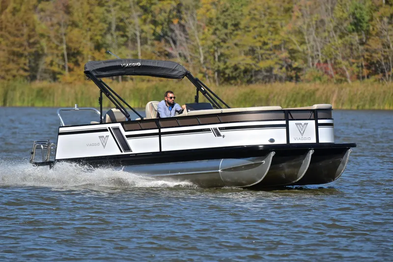 Slide: The Image of 2023 Viaggio L22R pontoon boat cruising on a lake. - 1