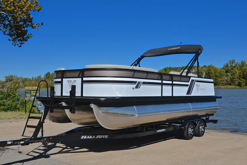 Slide: The Image of 2023 Viaggio L22R pontoon boat on a trailer by a lake. - 10