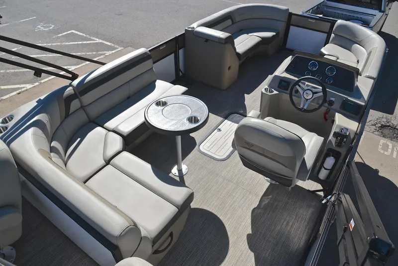 Slide: The Image of 2023 Viaggio L22R pontoon boat interior with plush seating and a central table. - 19