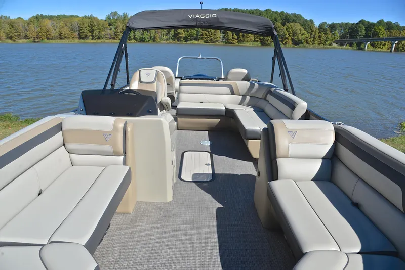 Slide: The Image of 2023 Viaggio L22R pontoon boat with spacious seating on a serene lake. - 20