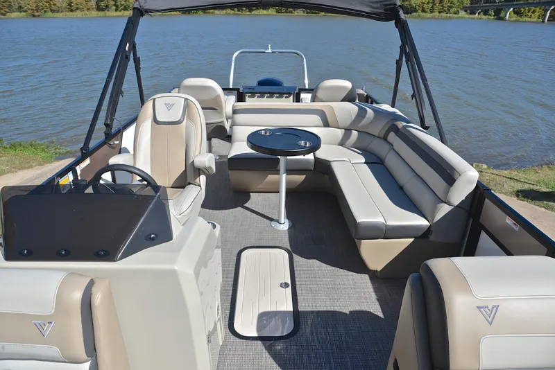Slide: The Image of 2023 Viaggio L22R pontoon boat with spacious seating and table on a lake. - 22