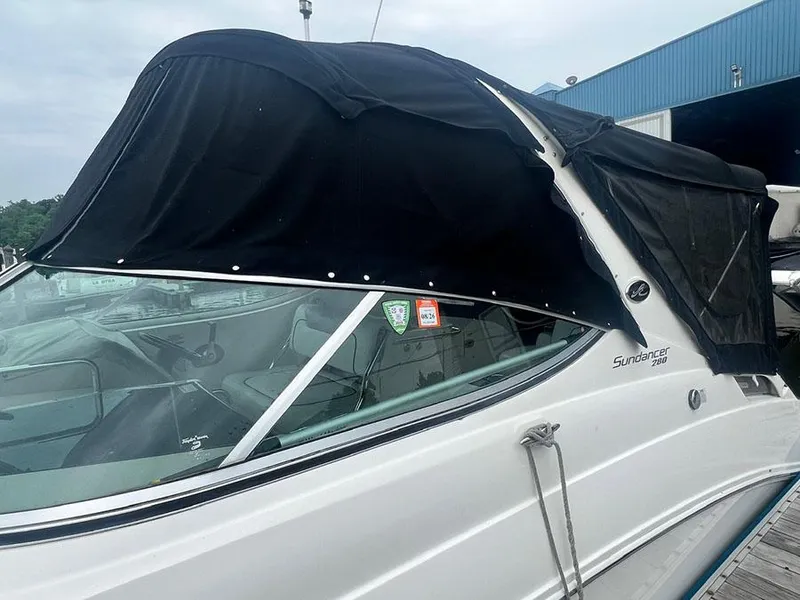 Slide: The Image of 2010 Sea Ray 280 Sundancer with black canvas cover docked at marina. - 2