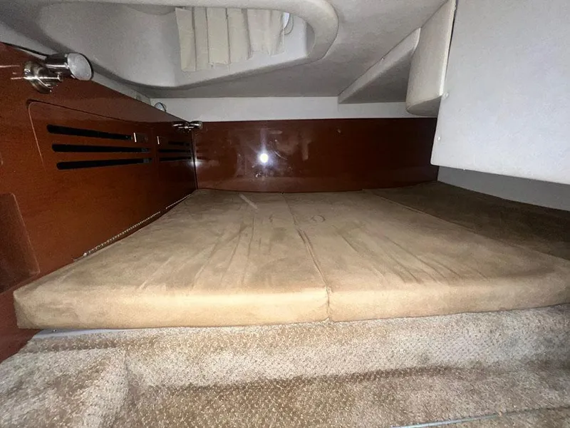 Slide: The Image of Interior cabin of 2010 Sea Ray 280 Sundancer with cushioned sleeping area. - 20