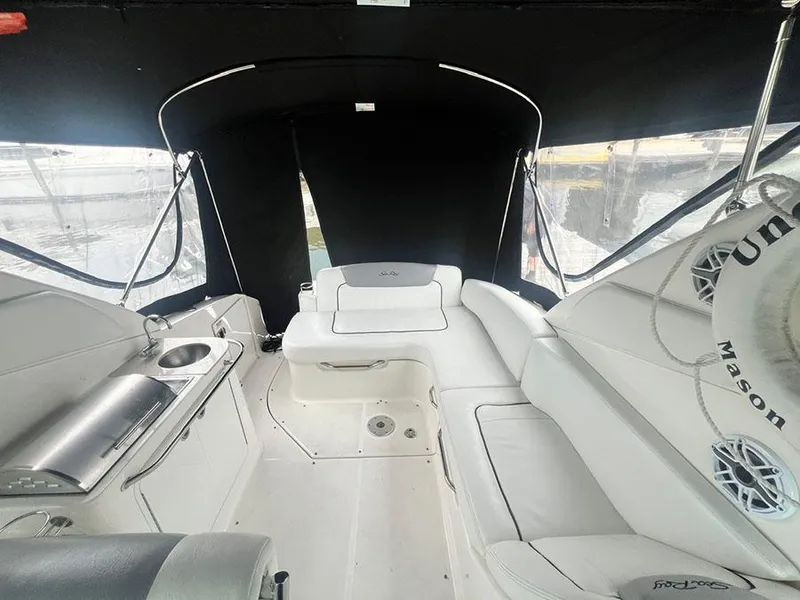 Slide: The Image of Interior of 2010 Sea Ray 280 Sundancer boat with white seating and kitchenette. - 4