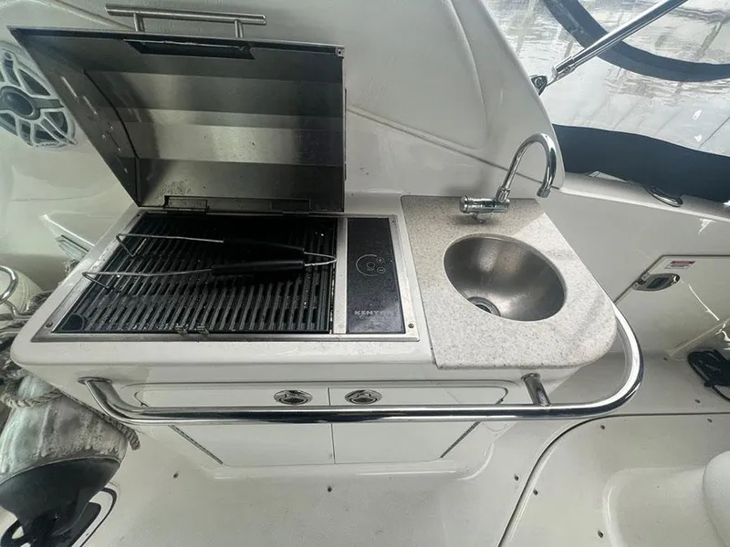 Slide: The Image of Outdoor kitchenette on a 2010 Sea Ray 280 Sundancer boat with grill and sink. - 5