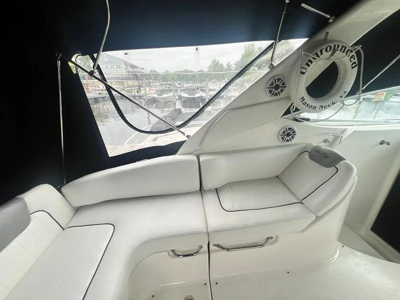 Slide: The Image of Interior seating area of a 2010 Sea Ray 280 Sundancer boat with marina view. - 7