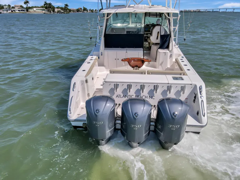 Slide: The Image of 2016 Pursuit 385OS boat with triple 350HP engines on water. - 10