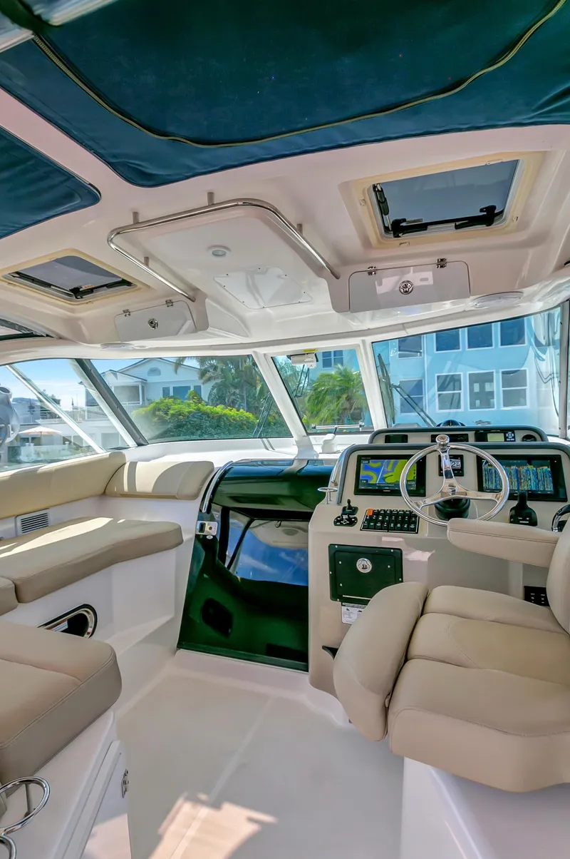 Slide: The Image of Interior of a 2016 Pursuit 385OS boat with modern navigation equipment. - 13