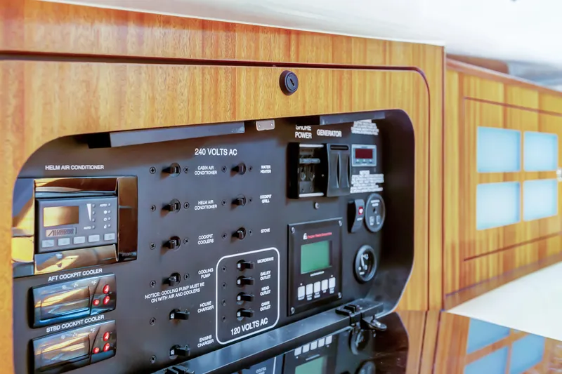 Slide: The Image of Control panel of a 2016 Pursuit 385OS boat with wood finish. - 15