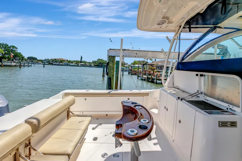 Slide: The Image of 2016 Pursuit 385OS boat with spacious deck and scenic waterfront view. - 16
