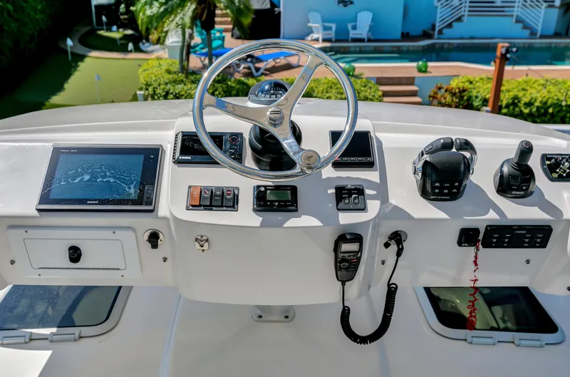 Slide: The Image of 2016 Pursuit 385OS boat helm with navigation equipment and controls. - 18