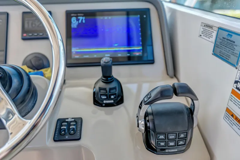Slide: The Image of 2016 Pursuit 385OS boat helm with Yamaha controls and navigation display. - 21