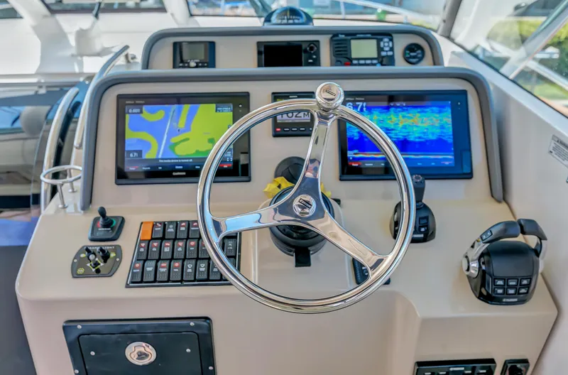 Slide: The Image of 2016 Pursuit 385OS boat helm with navigation screens and controls. - 23