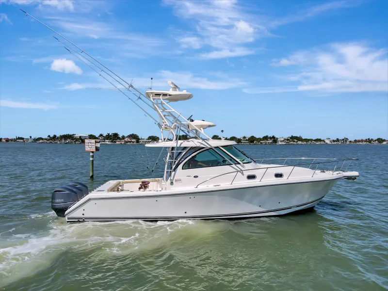 Slide: The Image of 2016 Pursuit 385OS boat cruising on a sunny day. - 3