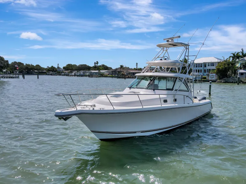 Slide: The Image of 2016 Pursuit 385OS boat on calm waters with a clear blue sky. - 7