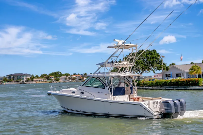 Slide: The Image of 2016 Pursuit 385OS boat cruising on a sunny day. - 8