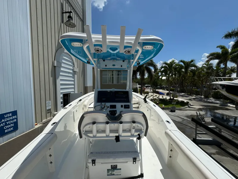 Slide: The Image of 2016 Tidewater 252 CC Adventure center console boat with T-top and fishing rod holders. - 11
