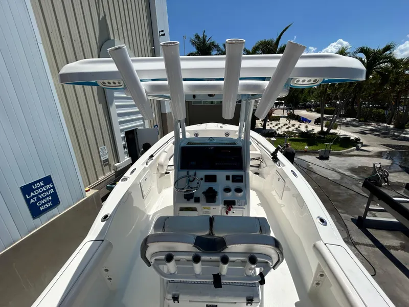 Slide: The Image of 2016 Tidewater 252 CC Adventure boat cockpit with helm station and rod holders. - 12