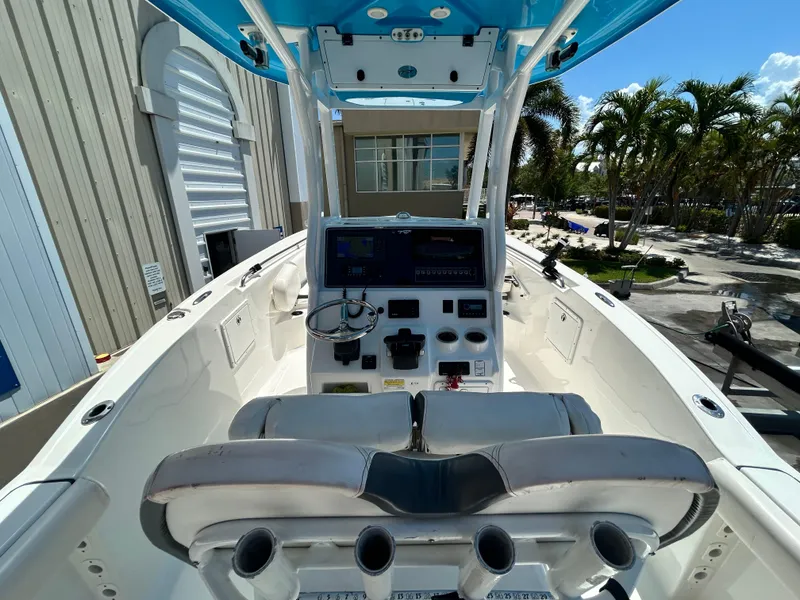 Slide: The Image of 2016 Tidewater 252 CC Adventure boat cockpit with control panel and seating. - 14
