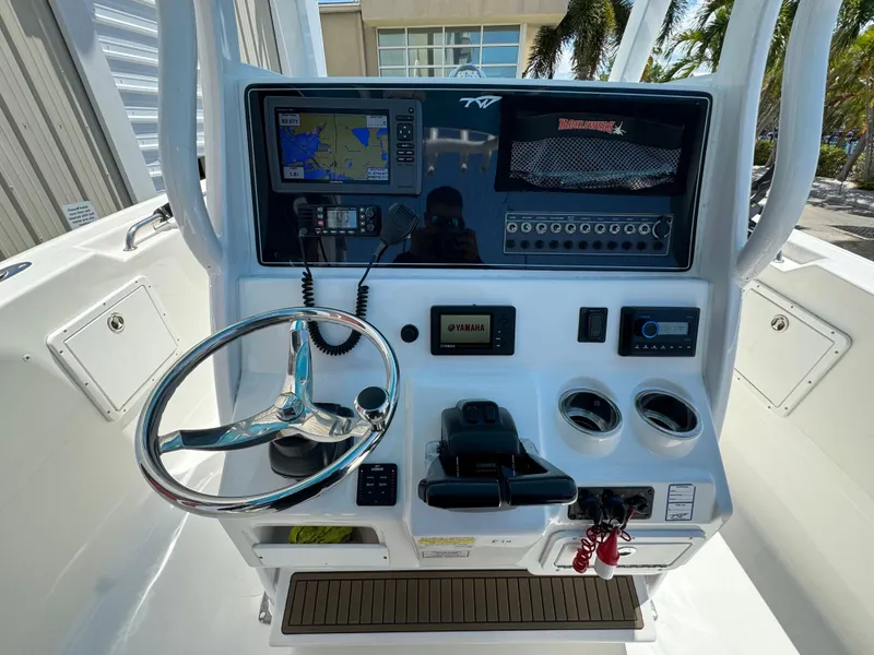 Slide: The Image of 2016 Tidewater 252 CC Adventure boat console with steering wheel and navigation equipment. - 16