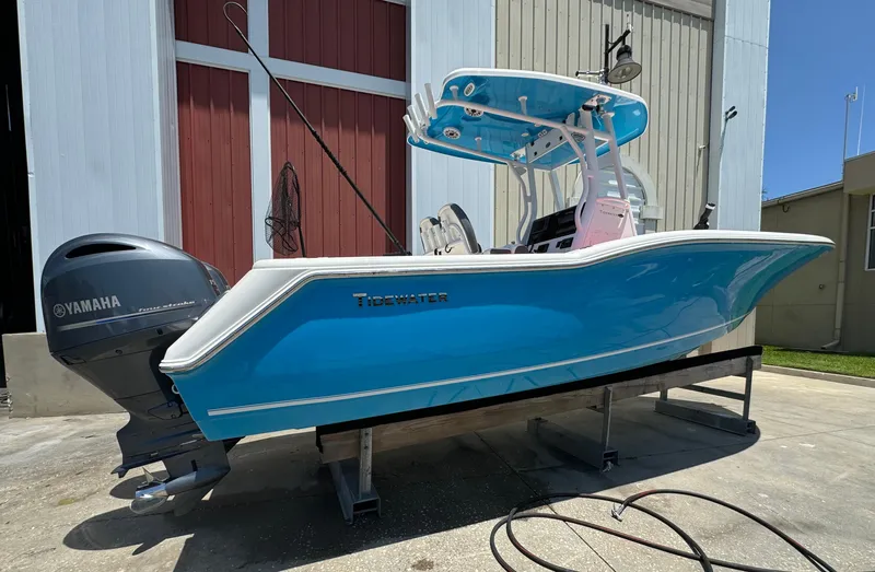 Slide: The Image of 2016 Tidewater 252 CC Adventure boat with Yamaha outboard motor on a stand. - 2