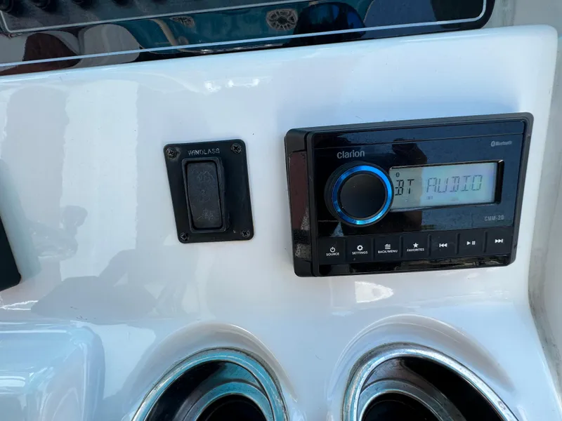 Slide: The Image of Clarion audio system on 2016 Tidewater 252 CC Adventure boat dashboard. - 21