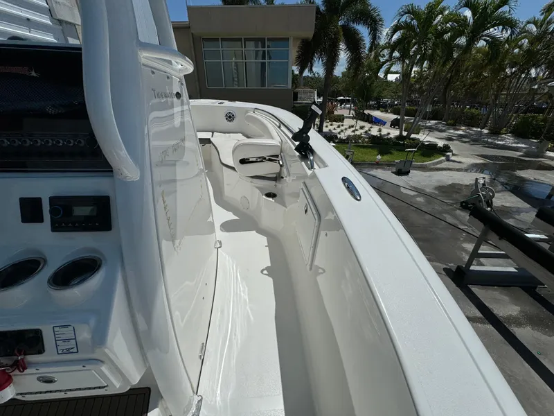 Slide: The Image of 2016 Tidewater 252 CC Adventure boat interior with white seating and control panel. - 25