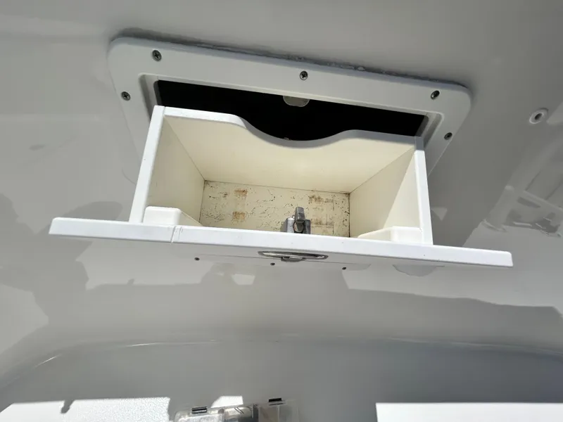 Slide: The Image of Open storage compartment on a 2016 Tidewater 252 CC Adventure boat. - 28