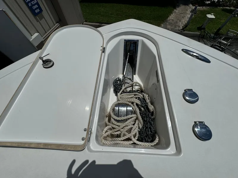 Slide: The Image of 2016 Tidewater 252 CC Adventure boat anchor storage compartment with rope and chain. - 31