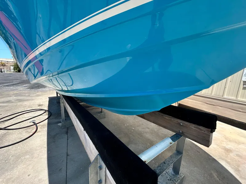 Slide: The Image of 2016 Tidewater 252 CC Adventure boat hull on trailer. - 7