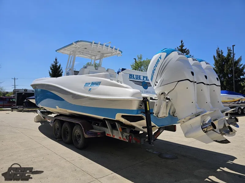 Slide: The Image of 2014 Deep Impact 36 Open boat on trailer with triple outboard engines. - 16