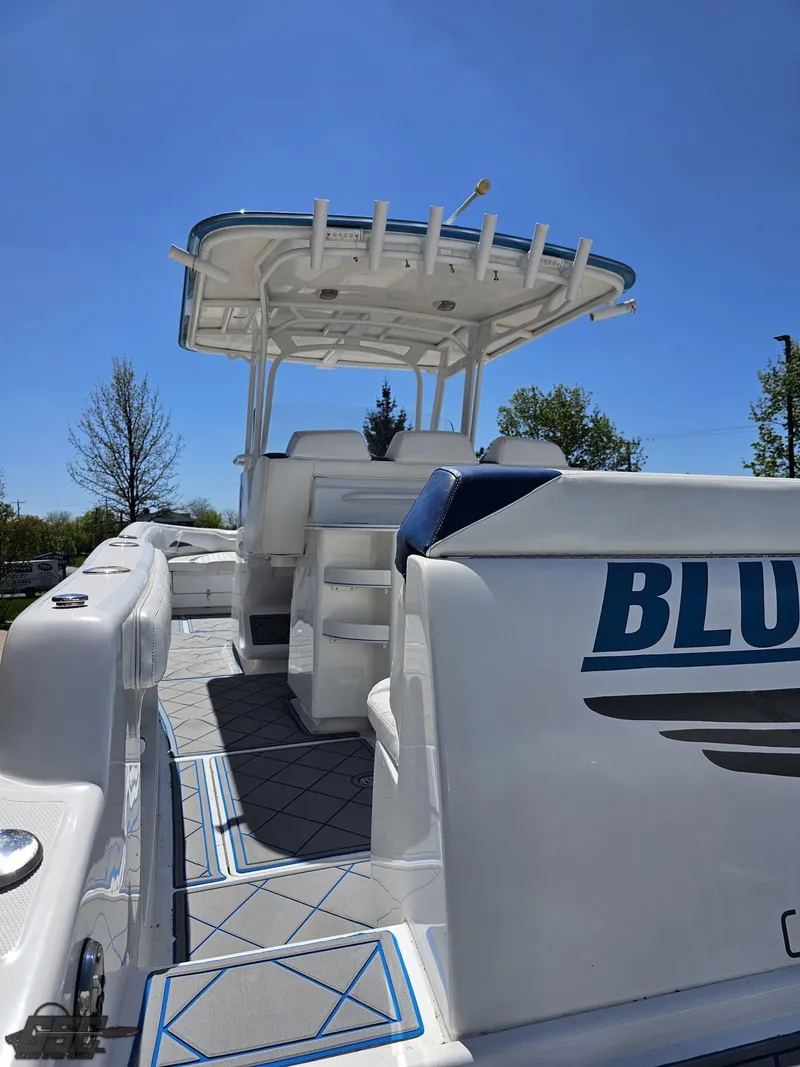 Slide: The Image of 2014 Deep Impact 36 Open boat with spacious deck and seating under clear blue sky. - 19