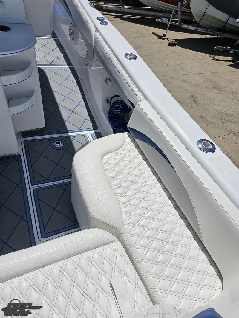 Slide: The Image of 2014 Deep Impact 36 Open boat with white quilted seating and blue accents. - 23