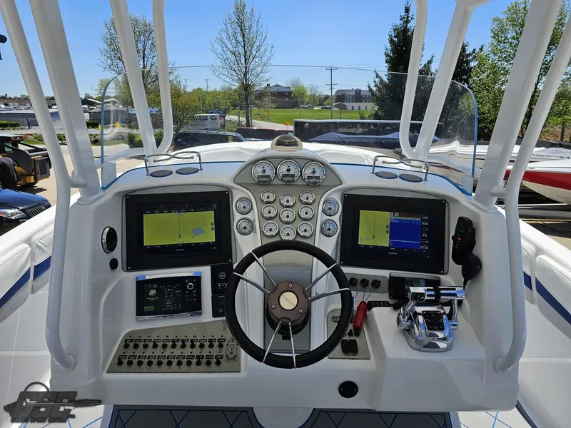 Slide: The Image of 2014 Deep Impact 36 Open boat dashboard with navigation screens and controls. - 30