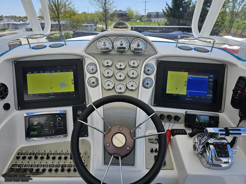 Slide: The Image of 2014 Deep Impact 36 Open boat dashboard with dual navigation screens and control panel. - 31