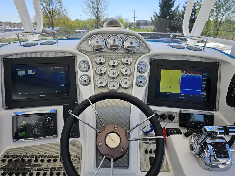 Slide: The Image of 2014 Deep Impact 36 Open boat dashboard with navigation screens and controls. - 32
