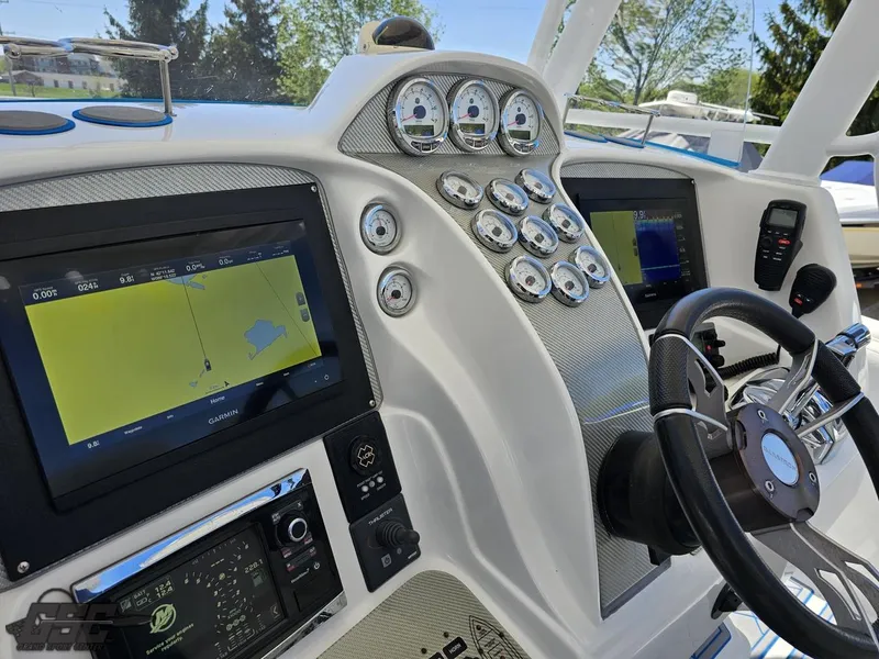 Slide: The Image of 2014 Deep Impact 36 Open boat dashboard with navigation screens and gauges. - 33