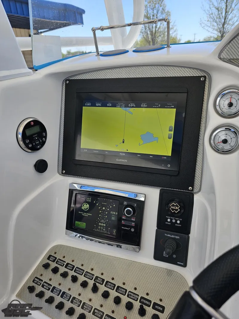 Slide: The Image of 2014 Deep Impact 36 Open boat dashboard with navigation and control systems. - 34