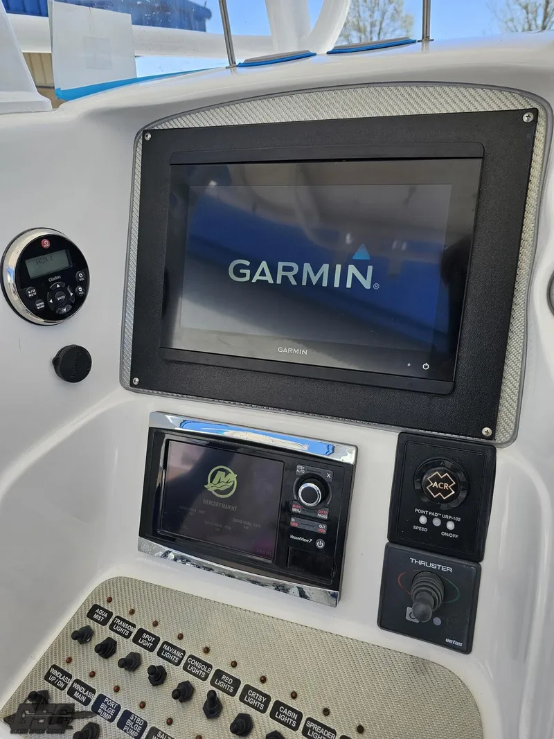 Slide: The Image of Control panel of a 2014 Deep Impact 36 Open boat with Garmin navigation system. - 35