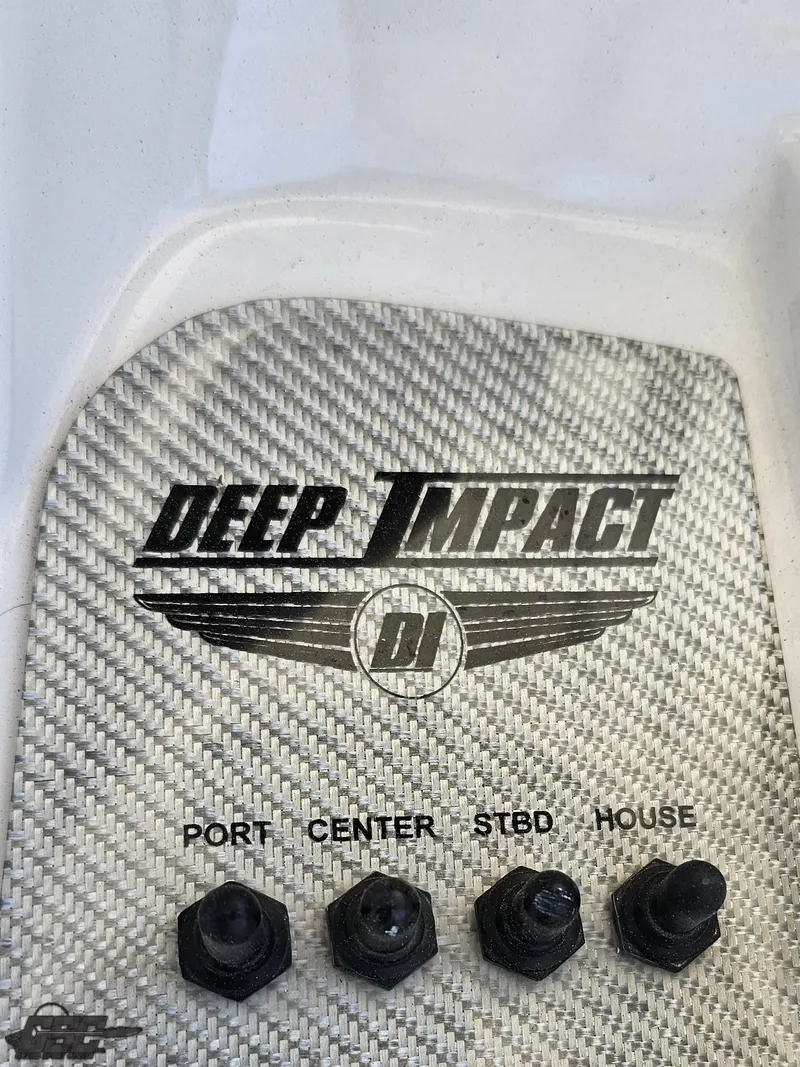 Slide: The Image of Deep Impact 36 Open 2014 boat control panel with logo and switches. - 42