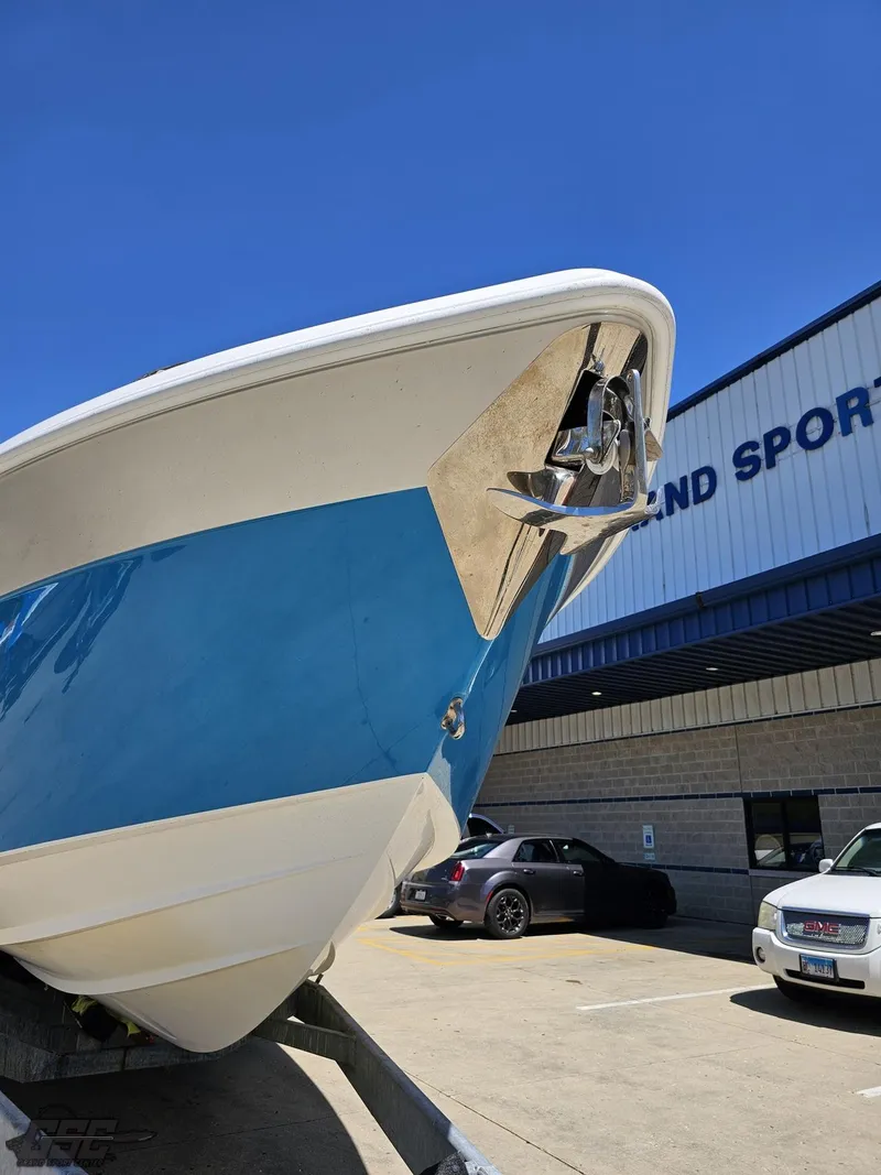 Slide: The Image of 2014 Deep Impact 36 Open boat in a parking lot, blue and white hull. - 7