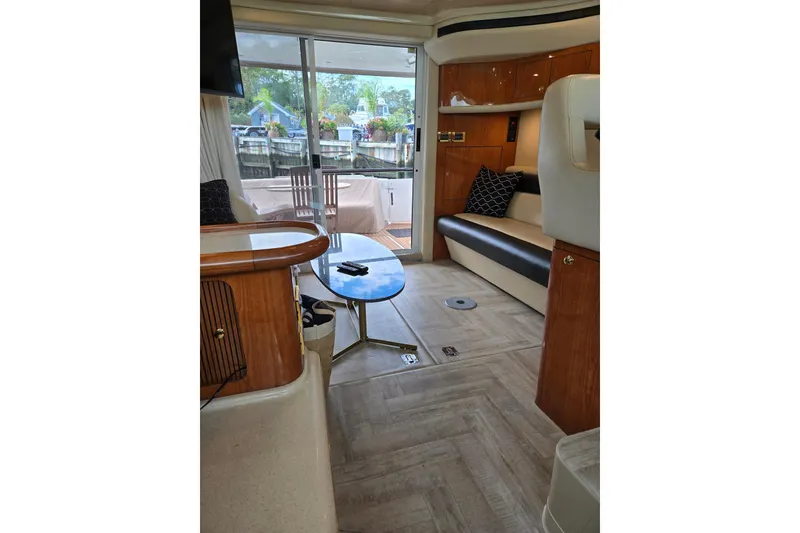 Slide: The Image of Interior of 2000 Sea Ray 400 Sedan Bridge yacht, featuring elegant seating and modern decor. - 10