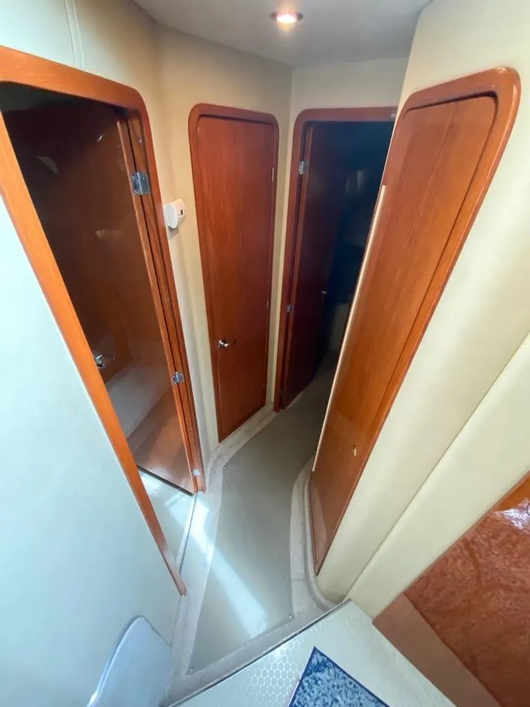 Slide: The Image of Interior hallway of 2000 Sea Ray 400 Sedan Bridge yacht with wooden doors. - 13