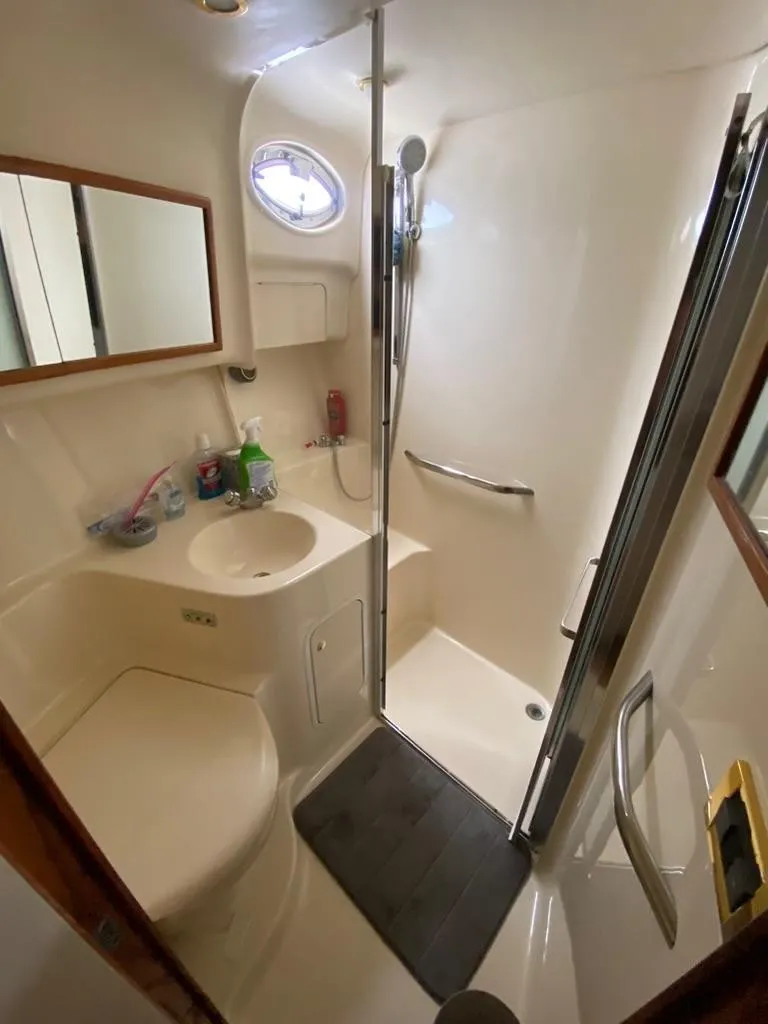 Slide: The Image of Bathroom interior of 2000 Sea Ray 400 Sedan Bridge yacht, featuring shower and sink. - 16