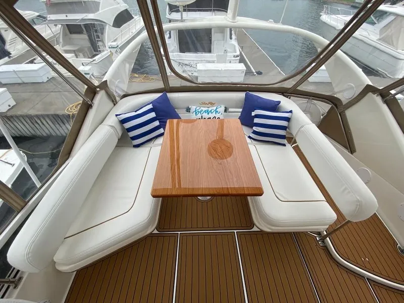 Slide: The Image of Luxurious seating area on 2000 Sea Ray 400 Sedan Bridge yacht with striped cushions. - 5