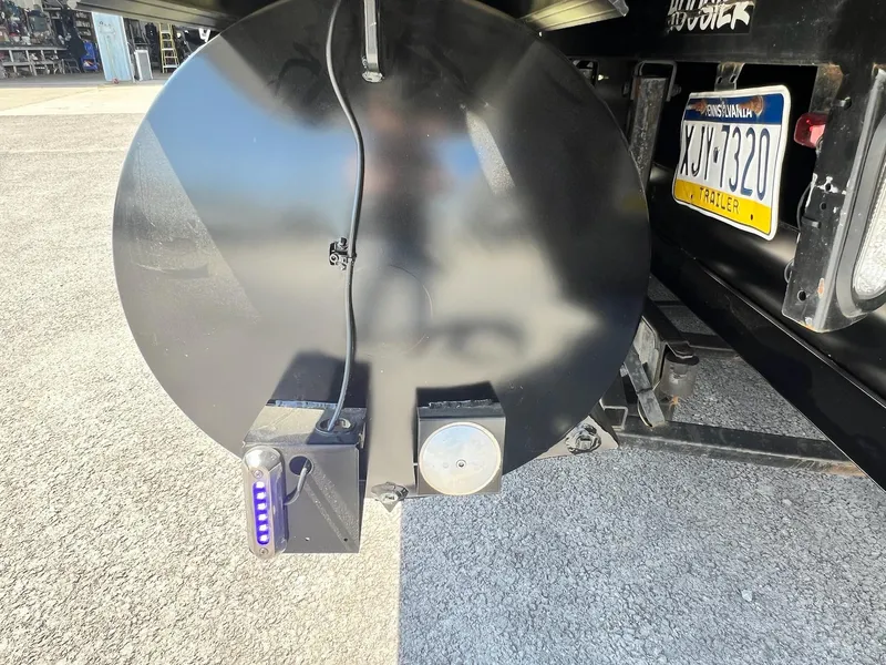 Slide: The Image of Close-up of the rear section of a 2024 Sylvan S3 CLZ DH Tritoon boat trailer. - 12